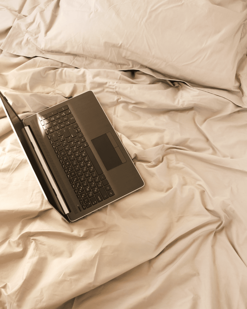 laptop on bed. Sustainable digital content strategy